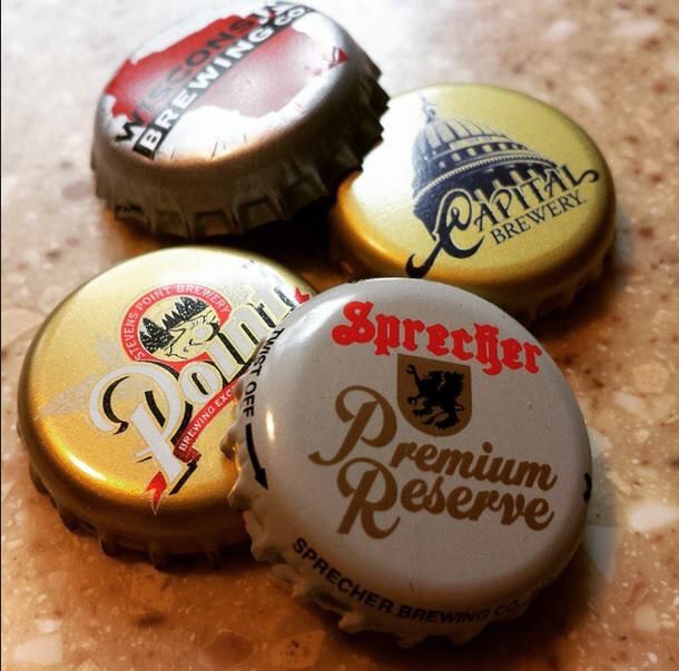 three beer bottle caps sitting on top of a counter