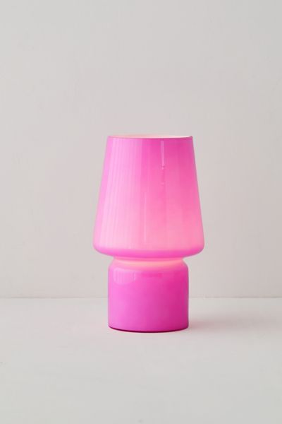 a pink lamp sitting on top of a white table