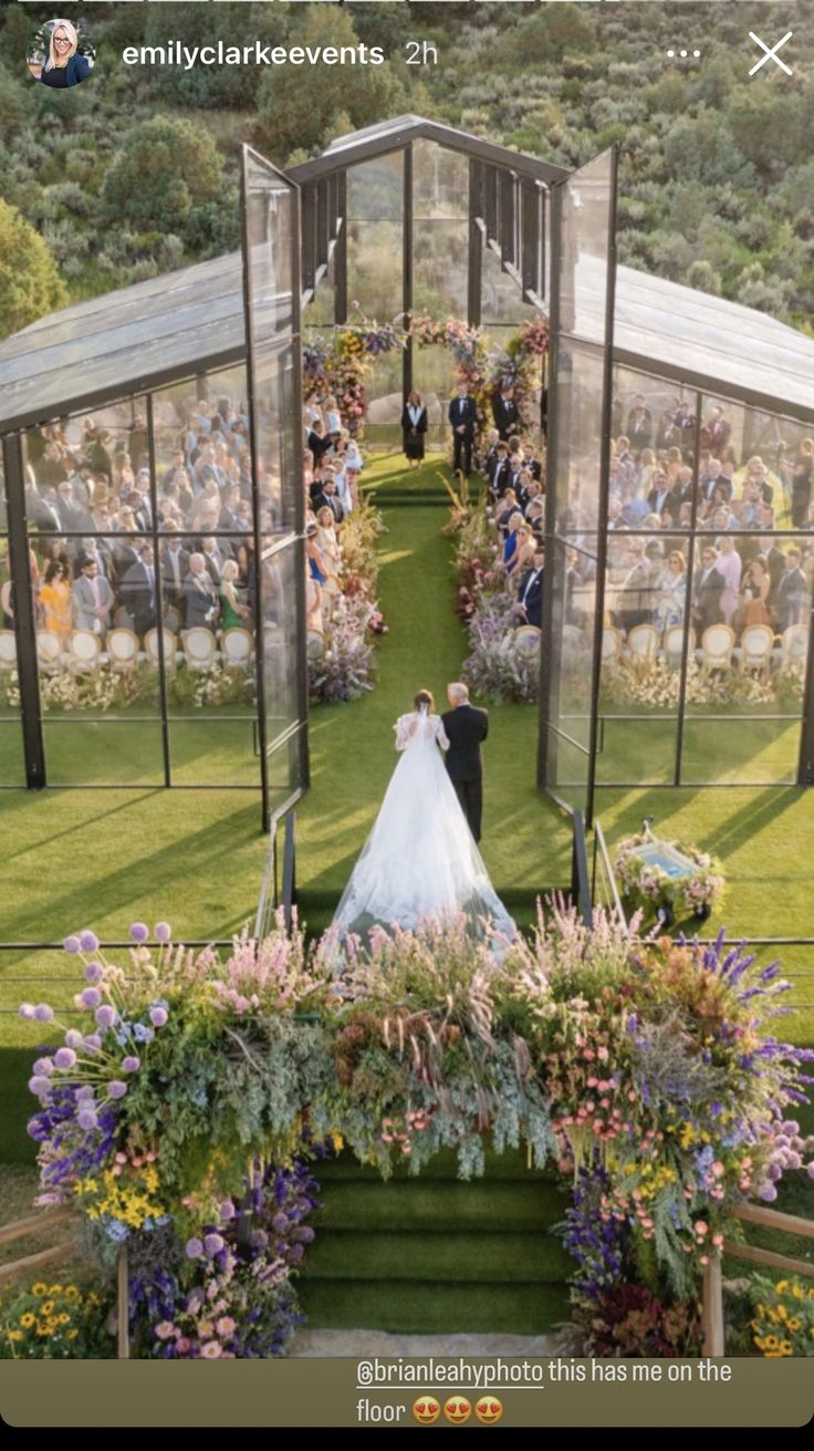 a wedding photo taken from the top of a staircase in front of an outdoor ceremony