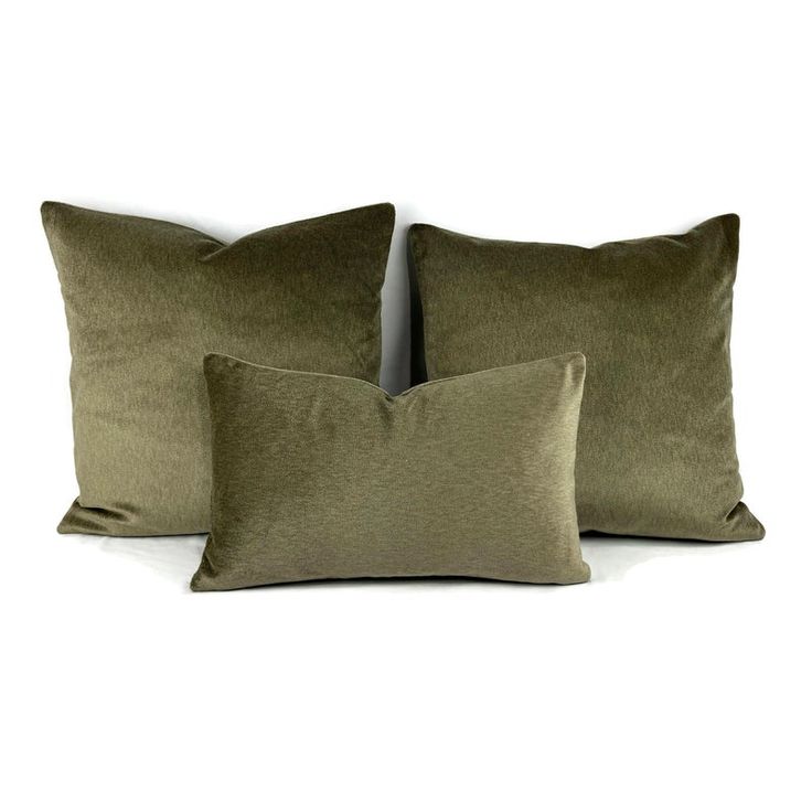 three olive green velvet pillows on a white background