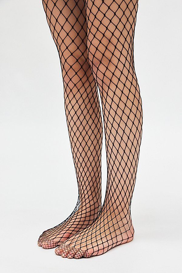 Forever favorite fishnet tights in a soft open-net finish. Features Fishnet tights Iconic netted tights Soft and stretchy Lightweight feel Content + Care 94% Nylon, 6% spandex Hand wash Imported Size + Fit S/M 4'10" -5'6" 90-130lbs L/XL 5'7" -5'6" 130-200lbs | Fishnet Tights in Black, Women's at Urban Outfitters Fish Net Bodysuit, Hand Fishnets, Netted Tights, Grunge Fishnets, Fishnets Outfit, Lesbian Vampire, Fishnet Stockings Outfit, Heathers Costume, Fish Net Tights Outfit