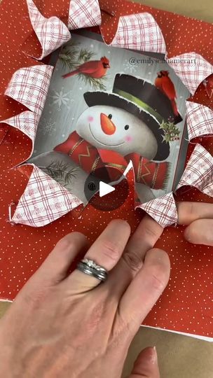 someone is making a snowman card out of paper