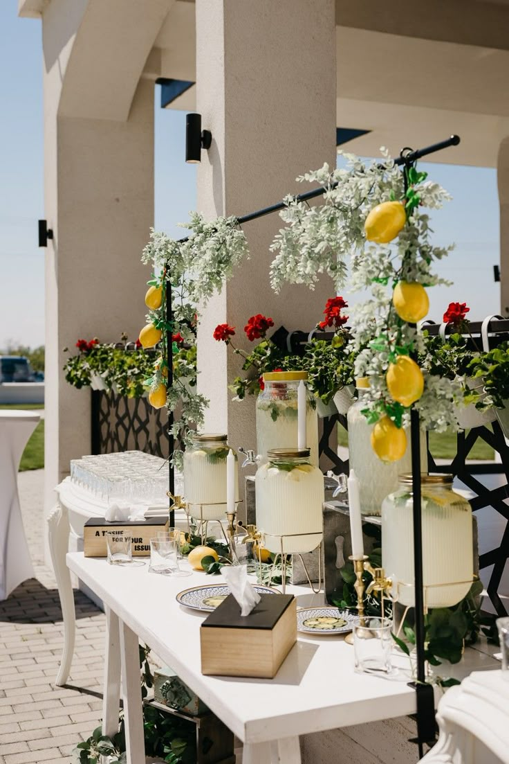 the tables are set up with flowers and candles for an outdoor wedding reception or party