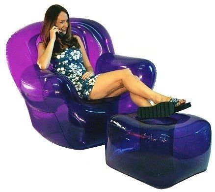 a woman sitting on a purple chair talking on her cell phone