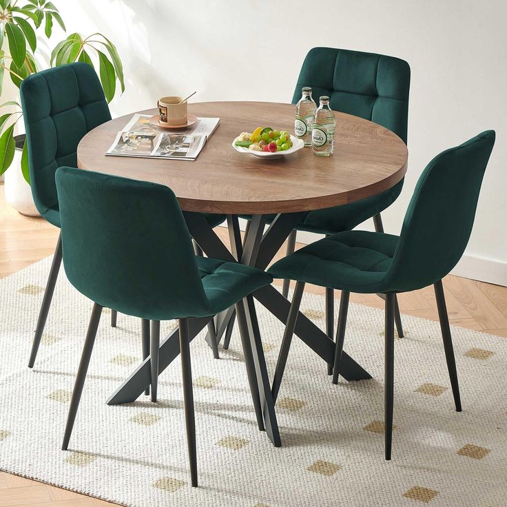 a dining table with green chairs around it