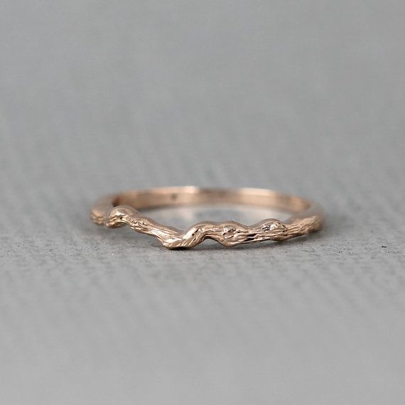 a gold wedding band that has been made to look like a branch