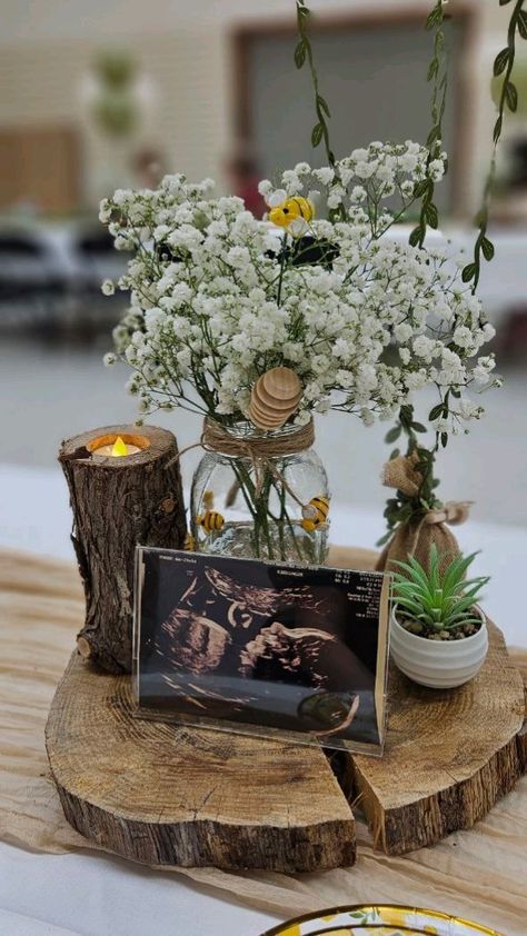 there is a vase with white flowers on the table next to a plate and candle