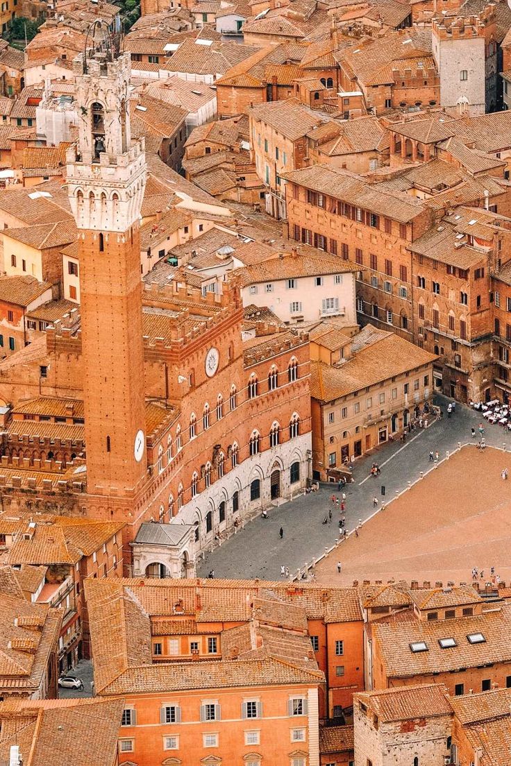 an aerial view of a city with tall buildings and a clock tower in the center