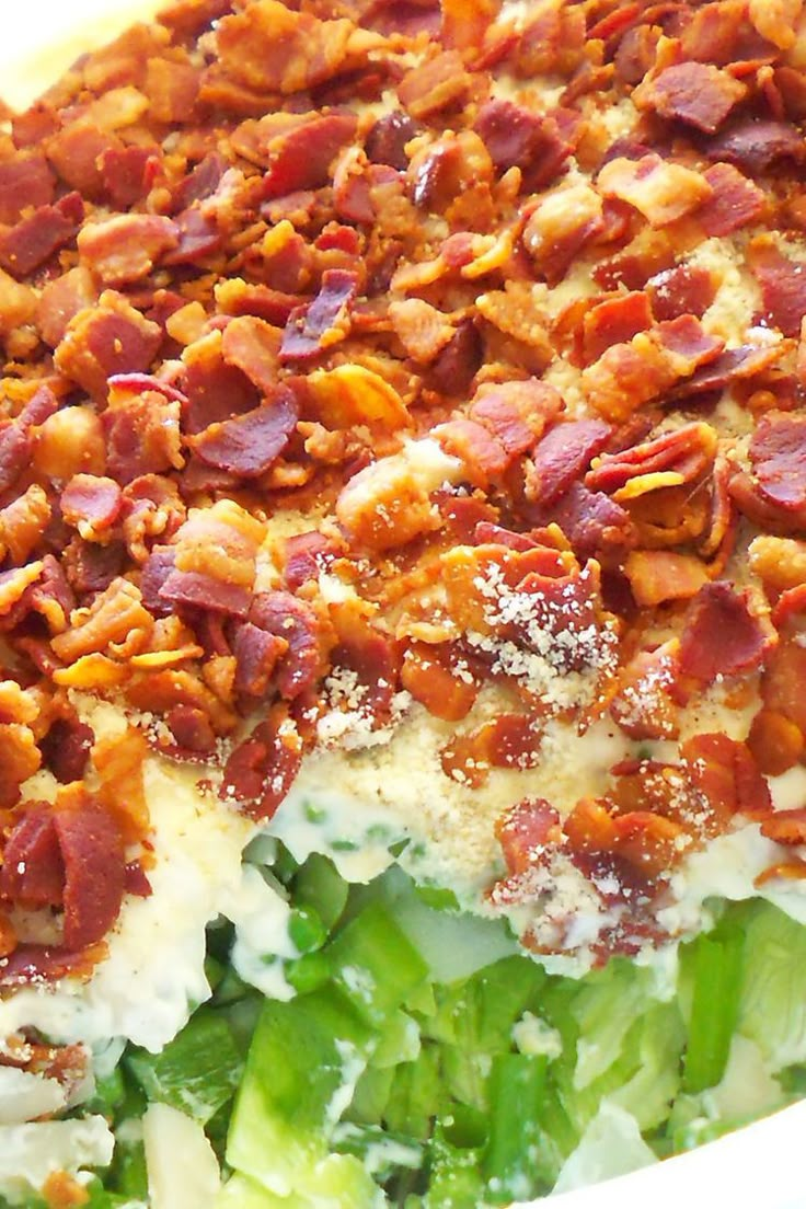 a casserole dish with bacon, cheese and lettuce on it's side