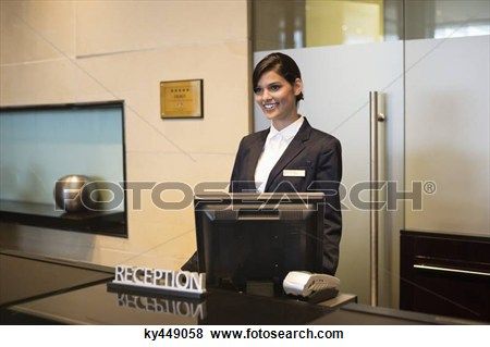 a woman standing behind a counter in an office