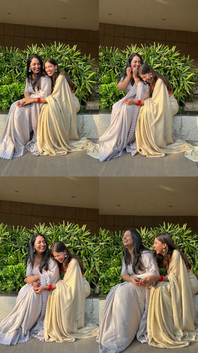 two women sitting on the ground with their arms around each other