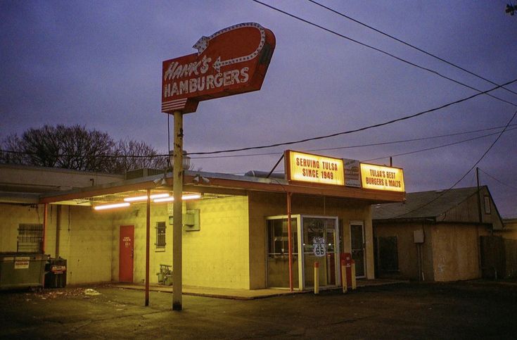 a restaurant called wendy's hamburgers with neon signs