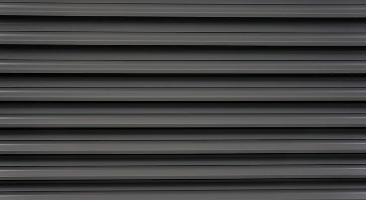 an image of the side of a building that is painted black and white with vertical lines