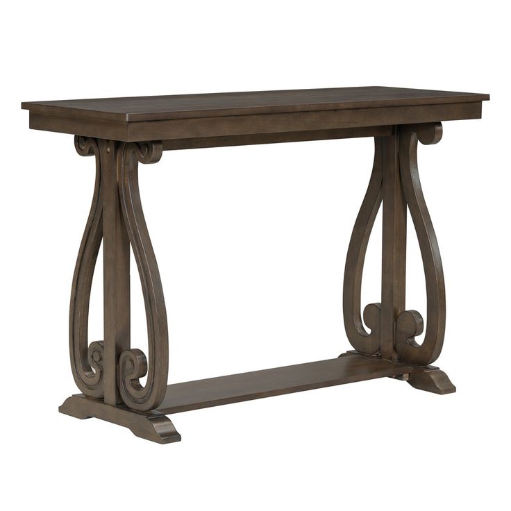 a wooden table with metal legs and an ornate design on the top, against a white background