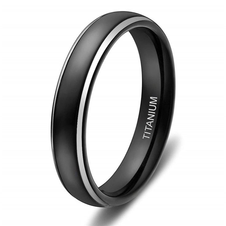 a black and white wedding ring with the word man at it's center, on a