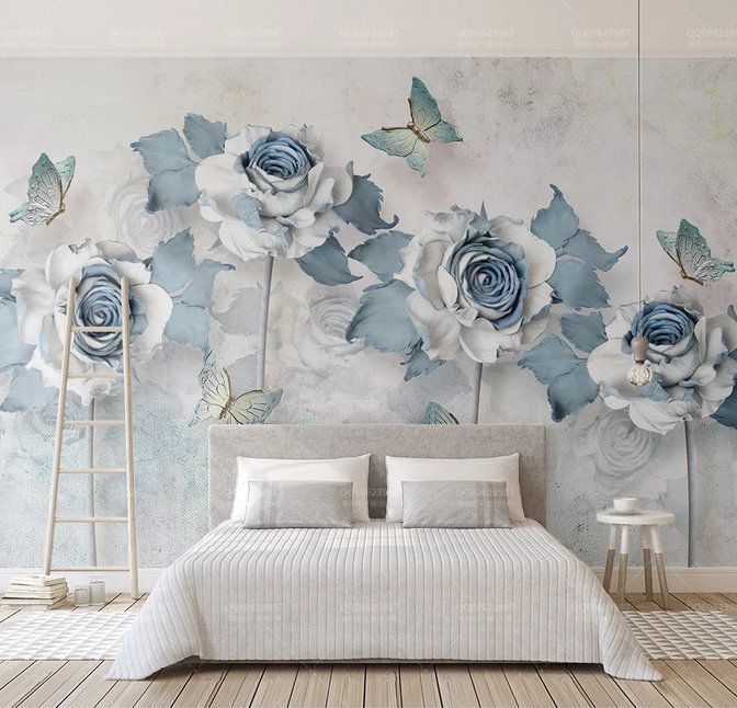 a bedroom with blue and white flowers on the wall