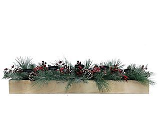 a wooden planter filled with pine cones and evergreens on top of a white wall