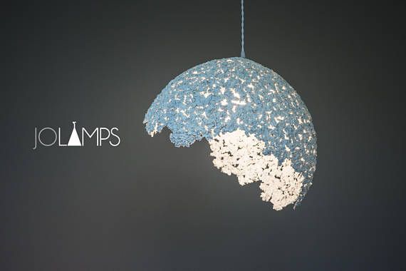 a blue and white light hanging from a string with the word jolimps on it