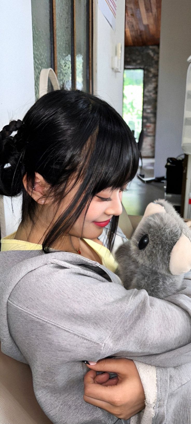 a woman holding a stuffed animal in her arms