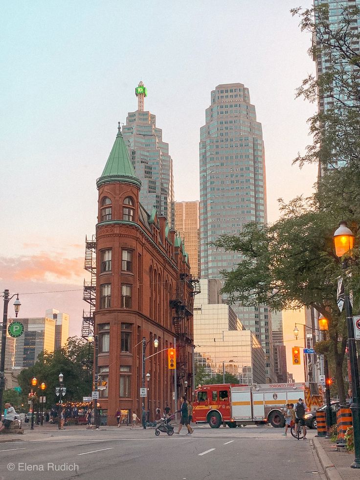 a city street with tall buildings in the background