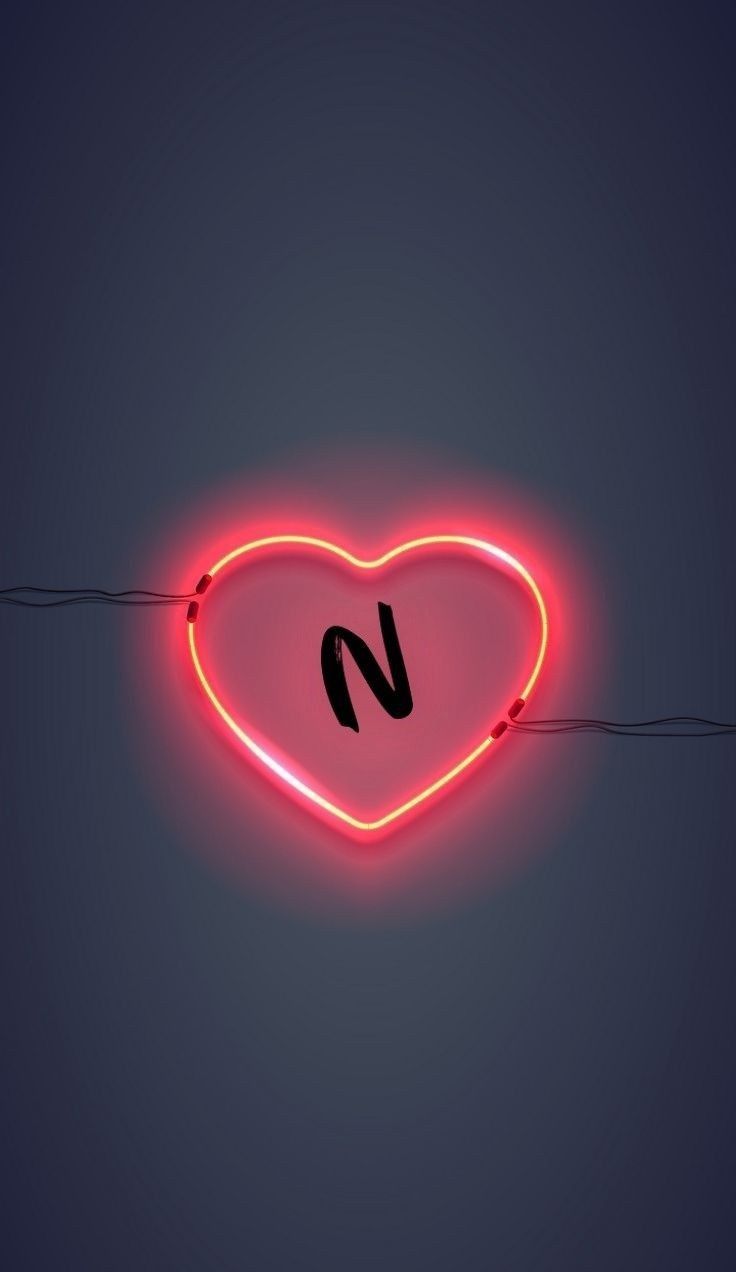 a red neon heart with the letter n on it's side hanging from a wire