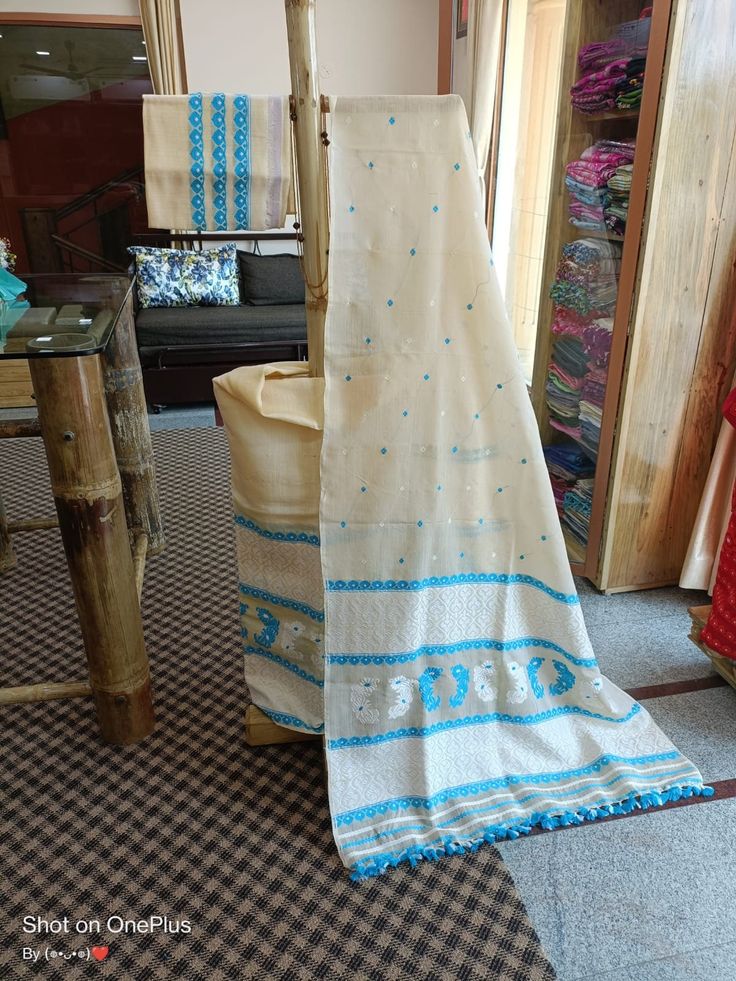 Welcome to our shop, where we take pride in offering you the finest craftsmanship and exquisite textiles. Introducing our pure Muga silk Mekhela Chador, a timeless masterpiece that beautifully combines tradition and elegance. Handwoven with care and precision, this Mekhela Chador is crafted from pure Muga silk, sourced from the silkworm Antheraea assamensis, which is indigenous to Assam, India. Muga silk is known for its lustrous golden hue, unparalleled sheen, and incredible durability. It is c Cream Cotton Silk Traditional Wear With Traditional Drape, Cream Cotton Silk Traditional Wear With Cutdana, Cotton Saree With Chikankari Embroidery For Navratri, Traditional Blue Mulmul Dupatta, Bohemian Cotton Saree For Wedding, Bohemian Cotton Wedding Saree, Traditional Cream Cotton Silk Salwar Kameez, Cotton Cutdana Blouse Piece For Eid, Bohemian Handloom Traditional Wear For Wedding