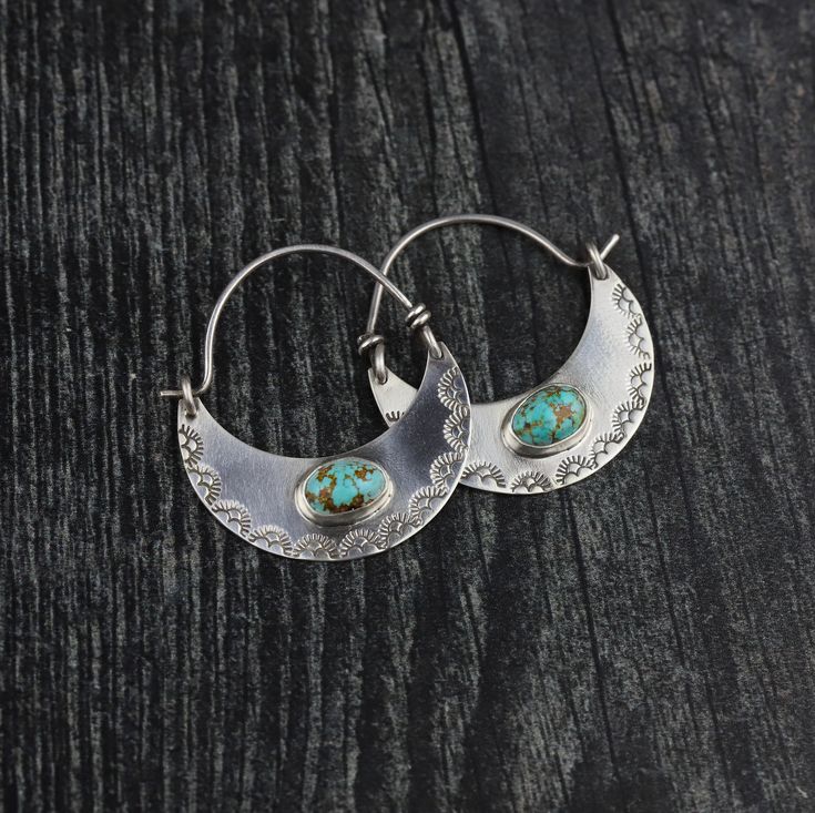 Ah, the moon. She's one of Mother Nature's most spectacular creations, isn't she? Personally, I love both hoop earrings and crescent moon shaped anything ,really. So it was only a matter of time before I flipped my OG crescent moon earrings upside down and made them Luna hoops! 🌙🌙 These one of a kind hand stamped LUNA HOOP EARRINGS are sure to become a show stopping fave. Each piece is hand crafted out of fine and STERLING SILVER, and features two dainty #8 TURQUOISE stones, ethically mined in Cresent Moon Earrings, Handmade Celestial Style Round Hoop Earrings, Handmade Celestial Sterling Silver Hoop Earrings, Handmade Sterling Silver Celestial Hoop Earrings, Adjustable Crescent Sterling Silver Hoop Earrings, Handmade Celestial Hoop Earrings, Bohemian Hoop Earrings With Moon Charm, Handmade Moon Shaped Bohemian Hoop Earrings, Celestial Crescent Hoop Earrings In Sterling Silver