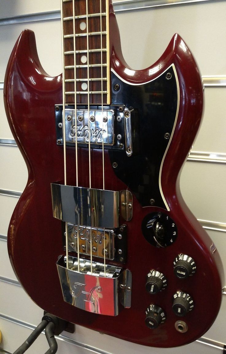 a red electric guitar hanging on the wall