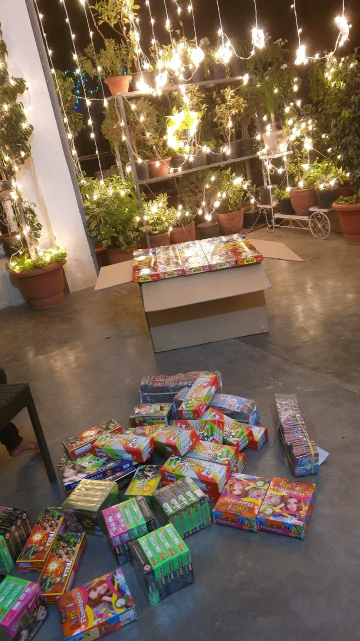 many presents are laid out on the floor in front of a window with fairy lights