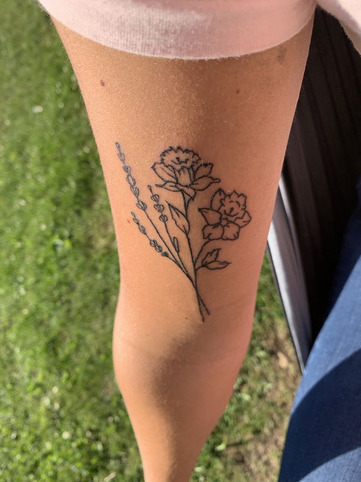 a woman's leg with flowers on it and the words, i love you in cursive writing