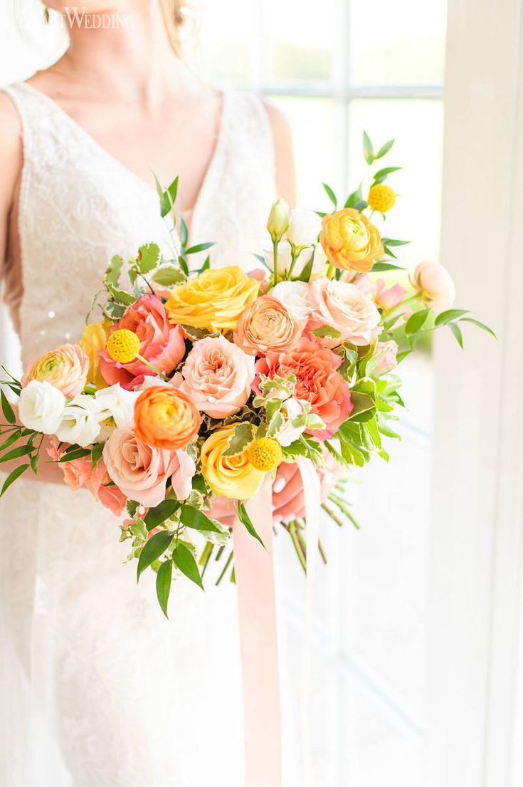 a bride holding a bouquet of flowers in her hand