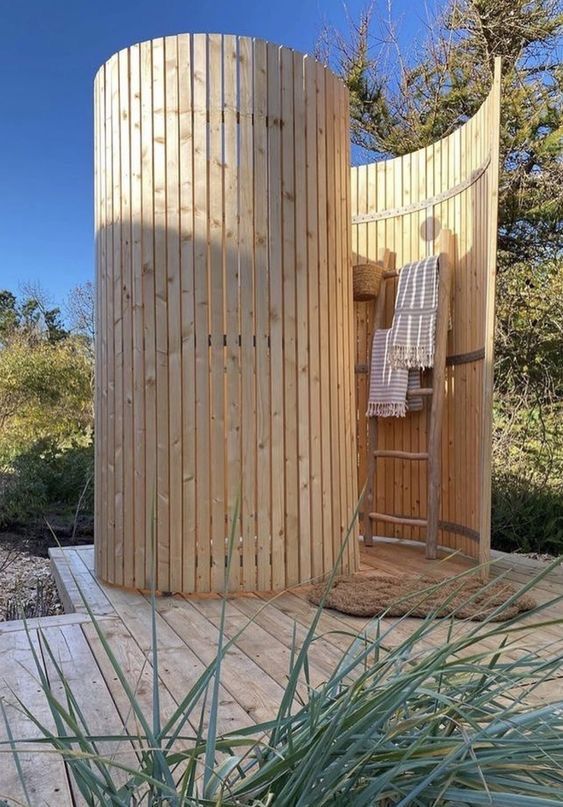 a wooden structure with a ladder in the middle and a towel hanging on it's side