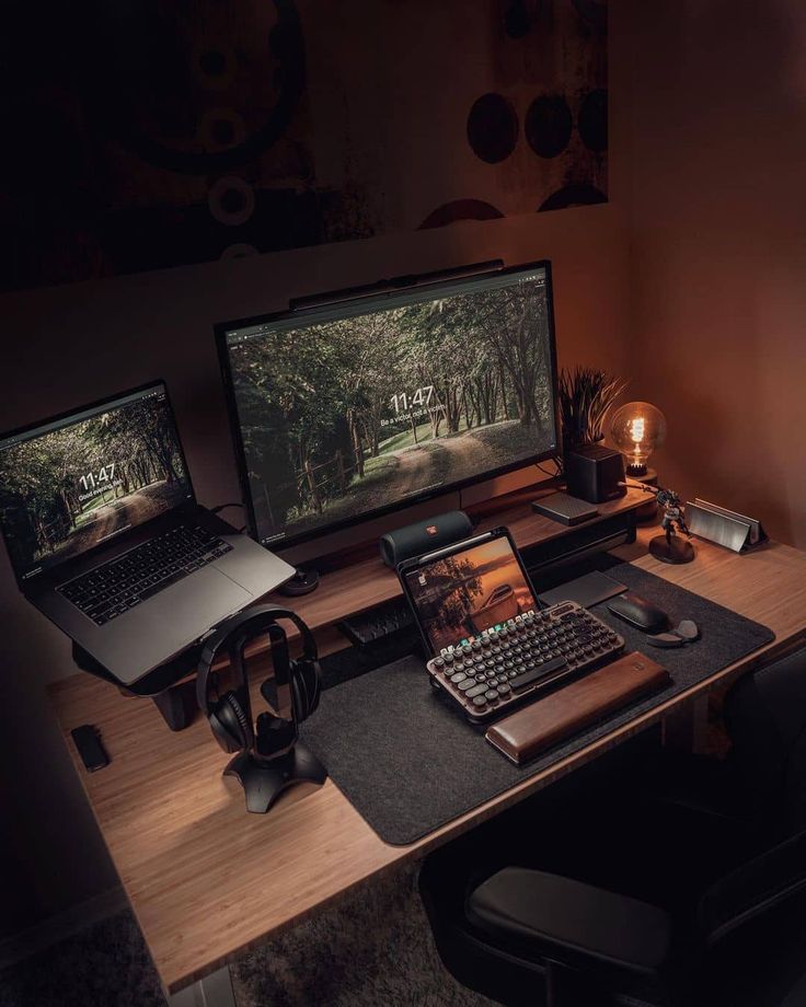 a computer desk with two monitors, keyboard and mouse on it in the dark room