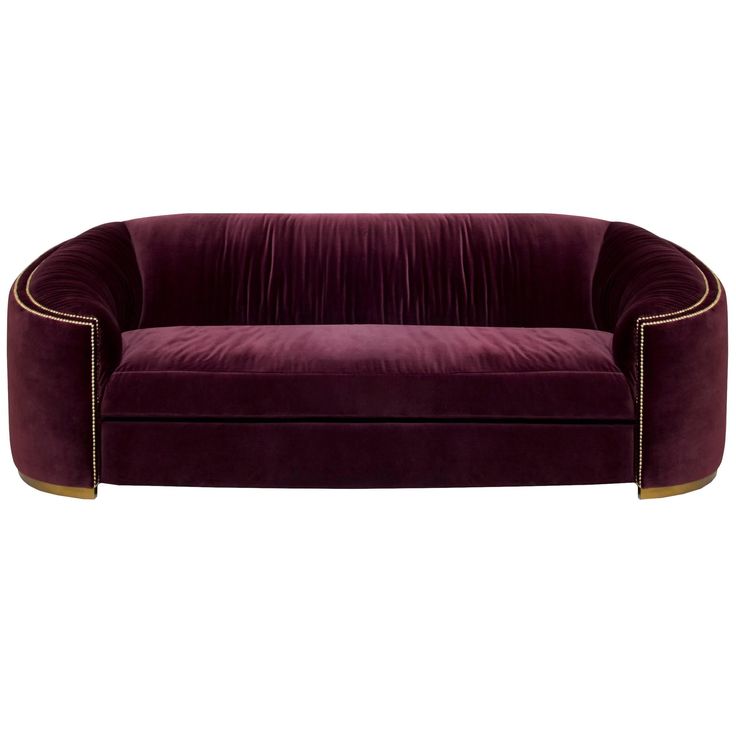 a purple velvet couch with gold trimmings on the arms and back, against a white background