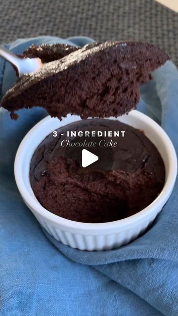 a bowl filled with chocolate cake on top of a blue cloth