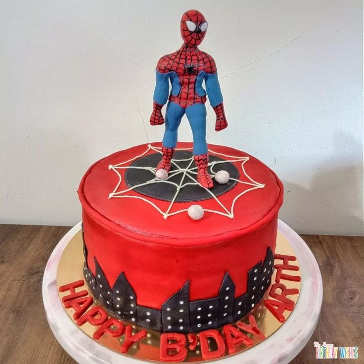 a birthday cake with a spiderman figure on top