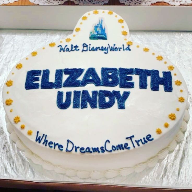 a birthday cake with the name elizabeth unddy on it in blue and white frosting