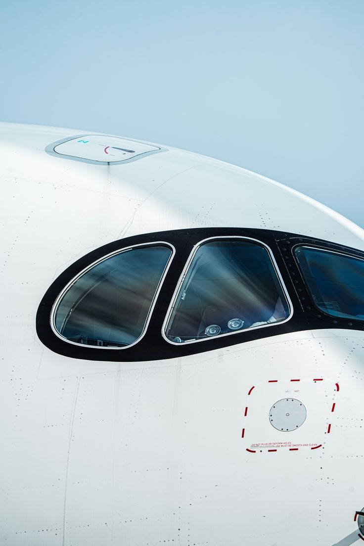 an airplane with its door open and the window partially closed, seen from inside it