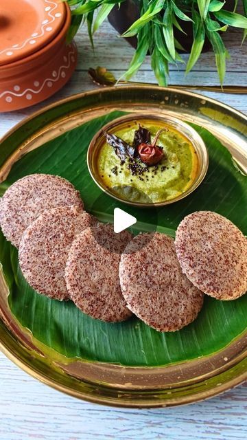 some food is sitting on a green plate with sauces and herbs in the background