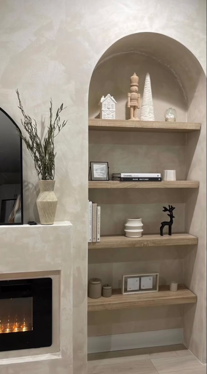 a living room with a fire place and bookshelves on the shelves in front of it