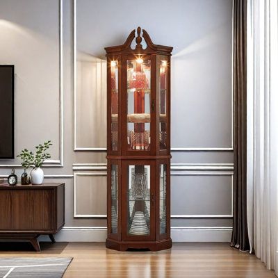 a tall wooden grandfather clock sitting in the corner of a living room