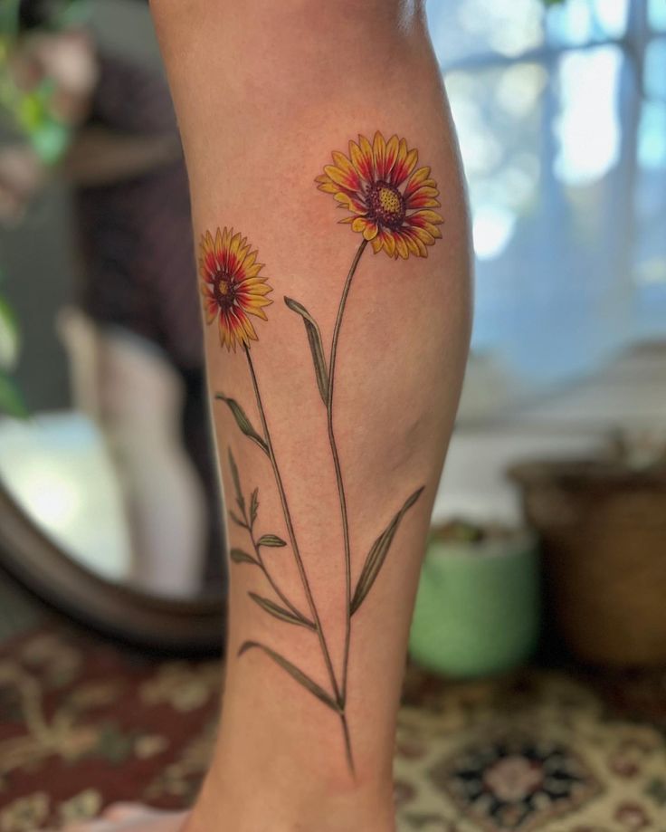 a woman's leg with a flower tattoo on it