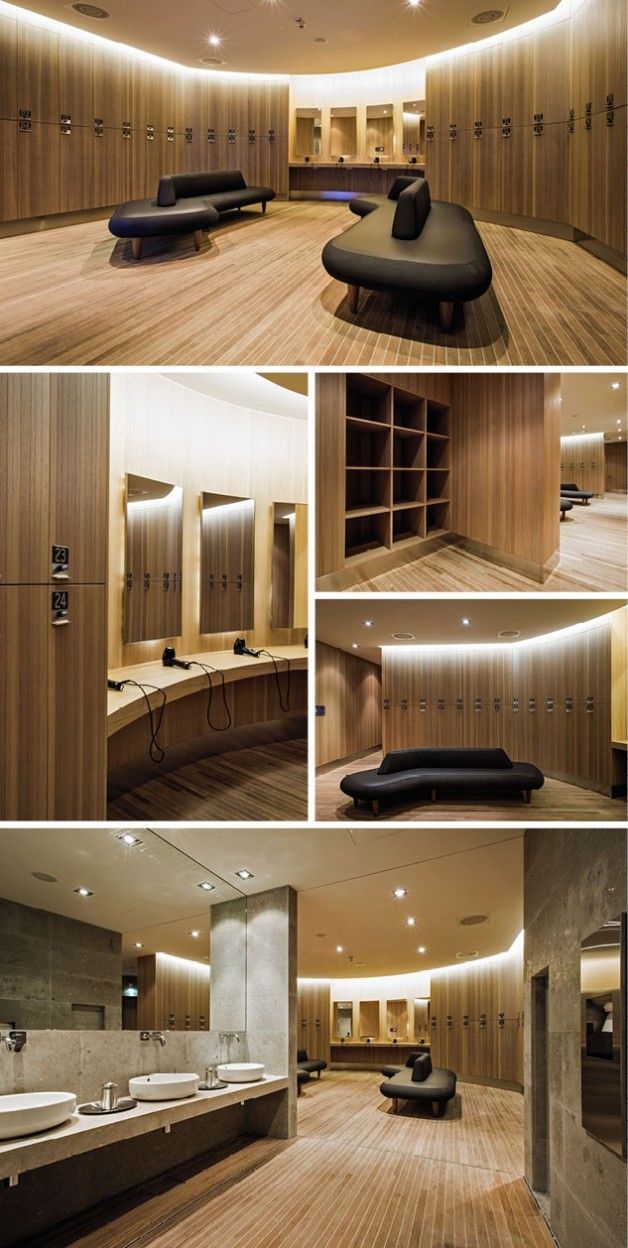 the interior of a modern bathroom with wood flooring and lighting on either side of the bathtub