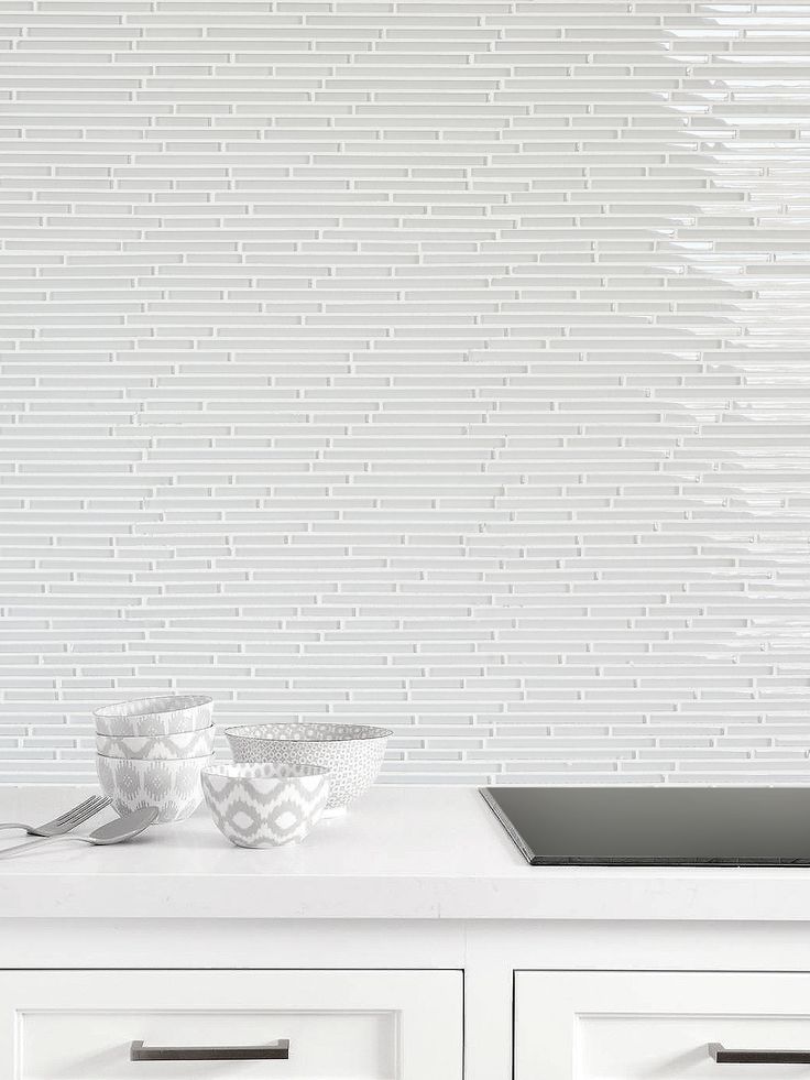 a white kitchen counter with two bowls on it