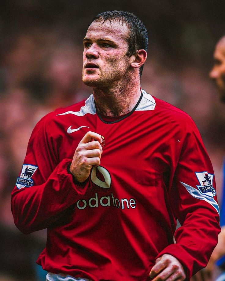 a man in red jersey holding a soccer ball