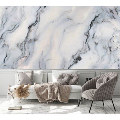 a living room with marble wallpaper and chairs