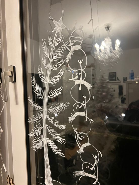 a frosted glass window with christmas decorations on it