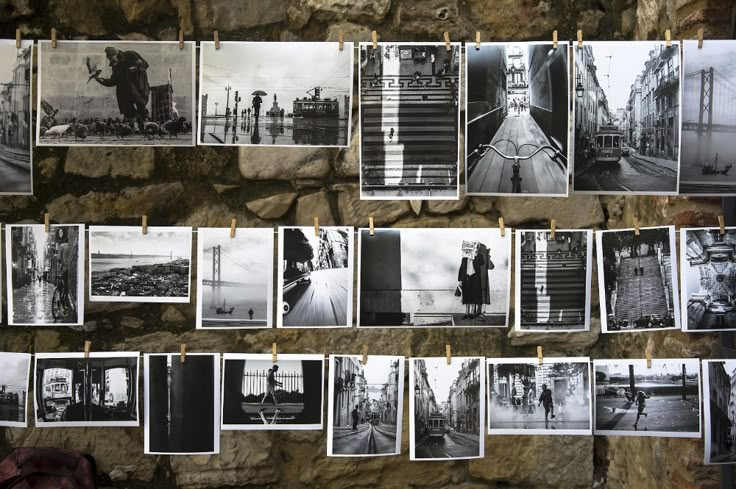 black and white photographs hanging on clothes pins