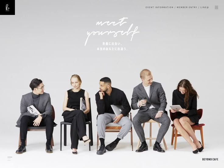 a group of people sitting next to each other on chairs in front of a white background