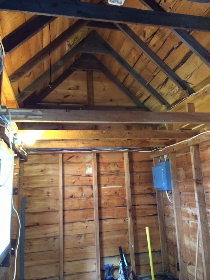 the inside of a building with wood paneling and exposed pipes in it's walls